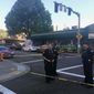 FILE - In this June 29, 2018, file photo, police officers stand at the scene of an earlier shooting outside The Cheerful Tortoise bar in Portland, Ore. A black man who was fatally shot by Portland State University campus police during a fight outside the bar had a permit to carry a concealed handgun. (Shane Dixon/The Oregonian via AP, File)