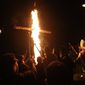 In this Saturday, April 23, 2016 photo, members of the Ku Klux Klan participate in cross burnings after a &quot;white pride&quot; rally in rural Paulding County near Cedar Town, Ga. In 2016, KKK leaders say they feel that U.S. politics are going their way, as a nationalist, us-against-them mentality deepens across the nation. (AP Photo/John Bazemore)