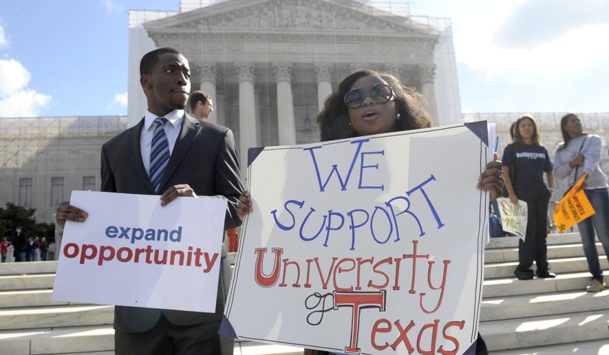 Jheanelle Wilkins of New Castle, Del., right, and Neo Moneri of Beltsville, Md., participate in a rally outside the Supreme Court in Washington, Wednesday, Oct. 10, 2012, supporting the University of Texas.. The Supreme Court is taking up a challenge to a University of Texas program that considers race in some college admissions. The case could produce new limits on affirmative action at universities, or roll it back entirely. (AP Photo/Susan Walsh) **FILE**