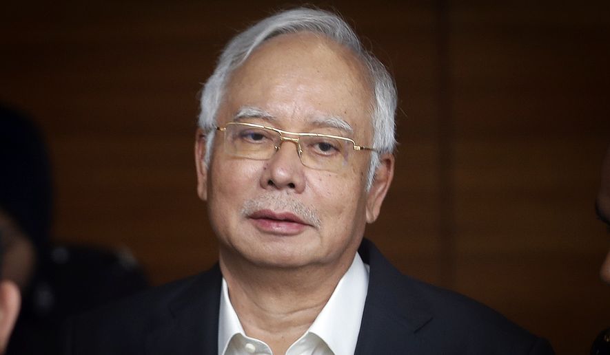 In this Thursday, May 24, 2018, file photo, former Malaysian Prime Minister Najib Razak arrives at the Malaysian Anti-Corruption Commission (MACC) Office in Putrajaya, Malaysia. Najib was arrested Tuesday by anti-graft investigators and will be charged over his alleged role in the multibillion-dollar looting of a state investment fund. (AP Photo/Vincent Thian, File)