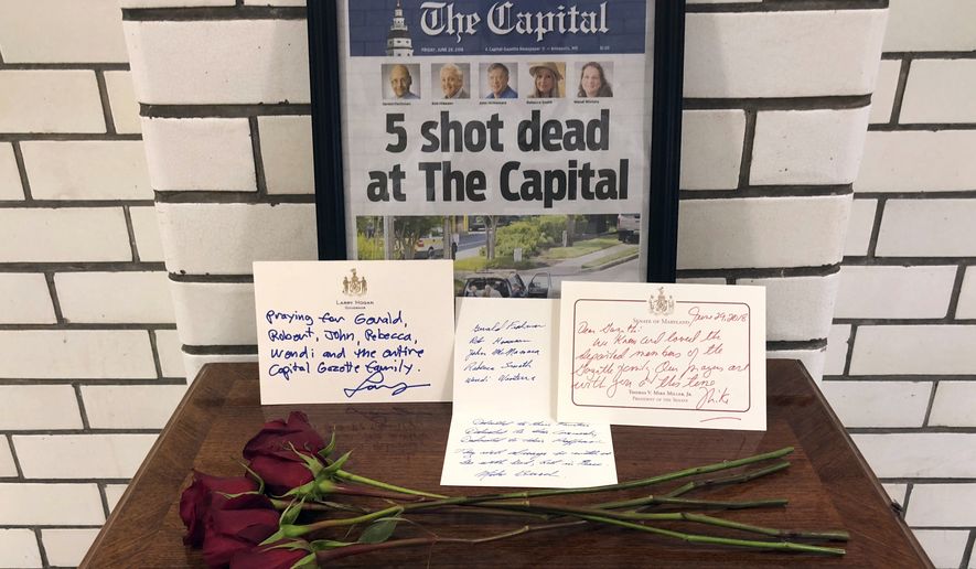 This Friday, June 29, 2018, file photo, shows letters and flowers forming a memorial at the State House, in Annapolis, Md., in honor of the five slain members of The Capital Gazette newspaper who were shot and killed in a newsroom attack. Online harassment from members of the public presents difficulties for the news outlets and journalists they target. The suspect in the deadly attack at the Capital Gazette had harassed the paper for years, but was never charged. (AP Photo/Brian Witte, File)