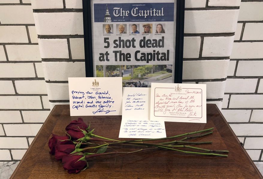 This Friday, June 29, 2018, file photo, shows letters and flowers forming a memorial at the State House, in Annapolis, Md., in honor of the five slain members of The Capital Gazette newspaper who were shot and killed in a newsroom attack. Online harassment from members of the public presents difficulties for the news outlets and journalists they target. The suspect in the deadly attack at the Capital Gazette had harassed the paper for years, but was never charged. (AP Photo/Brian Witte, File)