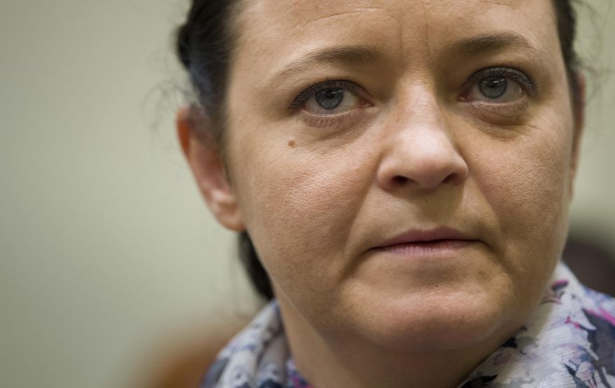 Terror suspect Beate Zschaepe stands in the court room in Munich, Germany, Tuesday, July 3, 2018. Zschaepe has been on trial since May 2013 as an alleged accomplice in a series of racially motivated murders by a neo-Nazi terrorist cell of the so-called National Socialist Underground (NSU) across Germany. (Peter Kneffel/dpa via AP, Pool)