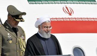 Iranian President Hassan Rouhani, right, arrives at the Zurich airport, in Kloten, Switzerland. Monday, July 2, 2018. Hassan Rouhani is on a two-day state visit to Switzerland. (KEYSTONE/Walter Bieri)