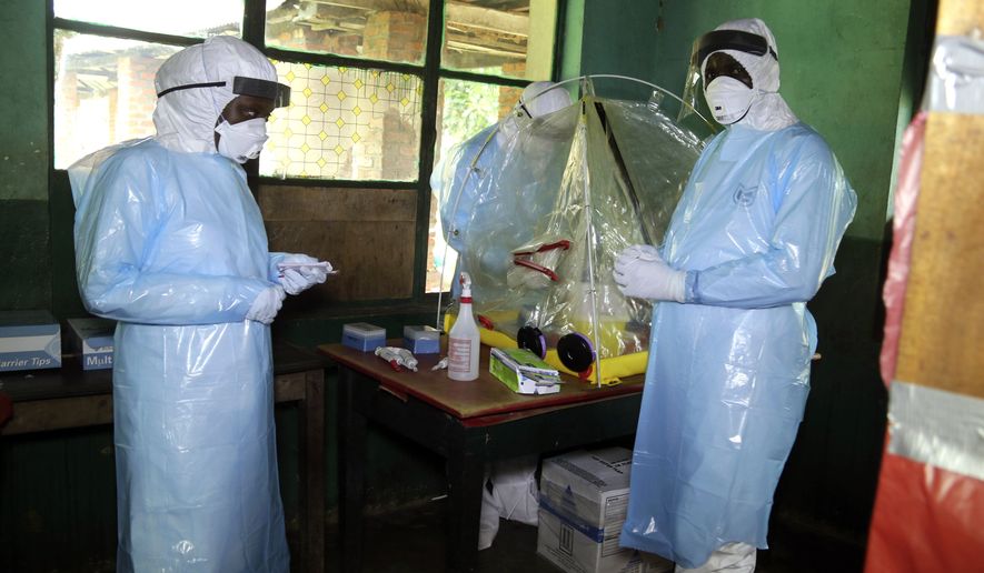 In this photo taken on Sunday, May 13, 2018, health care workers wear virus protective gear at a treatment center in Bikoro Democratic Republic of Congo. Congo&#x27;s latest Ebola outbreak has spread to a city of more than 1 million people, a worrying shift as the deadly virus risks traveling more easily in densely populated areas. Two suspected cases of hemorrhagic fever were reported in the Wangata health zones that include Mbandaka, the capital of northwestern Equateur province. The city is about 150 kilometers (93 miles) from Bikoro, the rural area where the outbreak was announced last week, said Congo&#x27;s Health Minister Oly Ilunga. (AP Photo/John Bompengo)