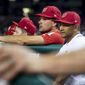 Washington Nationals manager Dave Martinez (4), right, and Ryan Zimmerman, center, stand in the dugout during a baseball game against the Boston Red Sox at Nationals Park, Monday, July 2, 2018, in Washington. (AP Photo/Andrew Harnik)