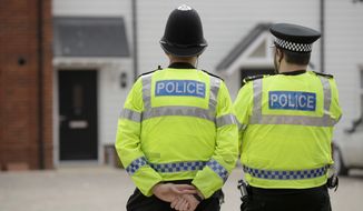British police officers stand facing a residential property in Amesbury, England, Wednesday, July 4, 2018. British police have declared a &amp;quot;major incident&amp;quot; after two people were exposed to an unknown substance in the town, and are cordoning off places the people are known to have visited before falling ill.  (AP Photo/Matt Dunham)