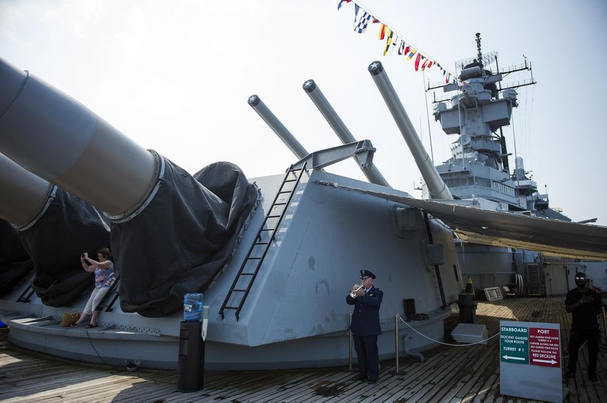 Lt. Col. (Ret.) William LcLean plays the National Anthem before a U.S. Citizenship and Immigration Services naturalization ceremony aboard the USS New Jersey Wednesday, July 4, 2018 in Camden, N.J. (Joe Lamberti/Camden Courier-Post via AP) **FILE**