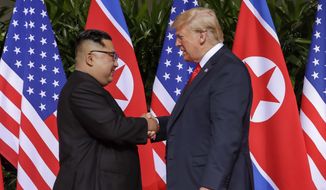 In this June 12, 2018, file photo, U.S. President Donald Trump, right, shakes hands with North Korean leader Kim Jong-un at the Capella resort on Sentosa Island in Singapore. (AP Photo/Evan Vucci, File)