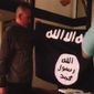 In this July 8, 2017, file image taken from FBI video and provided by the U.S. Attorney&#x27;s Office in Hawaii on July 13, 2017, Army Sgt. 1st Class Ikaika Kang holds an Islamic State group flag after allegedly pledging allegiance to the terror group at a house in Honolulu. Newly unsealed court documents from an investigation into the Hawaii-based Army soldier accused of attempting to support the Islamic State group, provides more details about his obsession with the group&#x27;s violence. (FBI/U.S Attorney&#x27;s Office, District of Hawaii via AP, File)