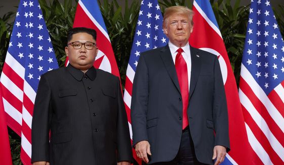 FILE - In this June. 12, 2018, file photo, U.S. President Donald Trump, right, stands with North Korean leader Kim Jong Un during a meeting on Sentosa Island, in Singapore. Diplomacy aimed at ending the North Korean nuclear crisis has produced little tangible progress since the historic June 12 summit between Trump and Kim. (AP Photo/Evan Vucci, File)