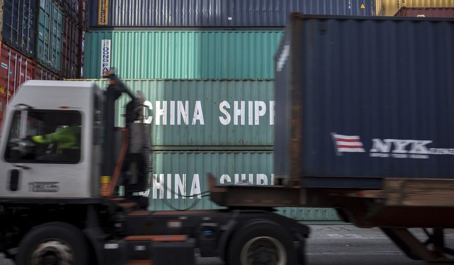 In this Thursday, July, 5, 2018, photo, a jockey truck passes a stack of 40-foot China Shipping containers at the Port of Savannah in Savannah, Ga. The United States and China launched what Beijing called the "biggest trade war in economic history" Friday, July 6, imposing tariffs on billions of dollars of each other's goods amid a spiraling dispute over technology. (AP Photo/Stephen B. Morton)