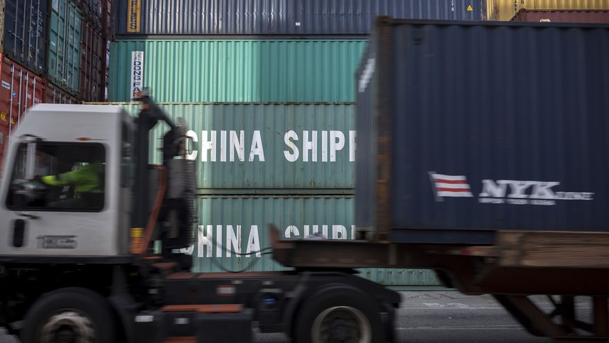 In this Thursday, July, 5, 2018, photo, a jockey truck passes a stack of 40-foot China Shipping containers at the Port of Savannah in Savannah, Ga. The United States and China launched what Beijing called the "biggest trade war in economic history" Friday, July 6, imposing tariffs on billions of dollars of each other's goods amid a spiraling dispute over technology. (AP Photo/Stephen B. Morton)