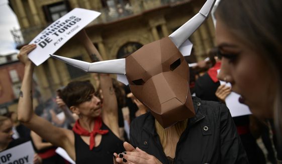 Demonstrators protest against bullfighting in front of the City Hall a day before of the famous San Fermin festival, in Pamplona, northern Spain, Thursday, July 5, 2018. The festival will begin on July 6 with the &#39;&#39;txupinazo&#39;&#39; opening ceremony, with people participating in bull runs, music and dance, through the old city. (AP Photo/Alvaro Barrientos)