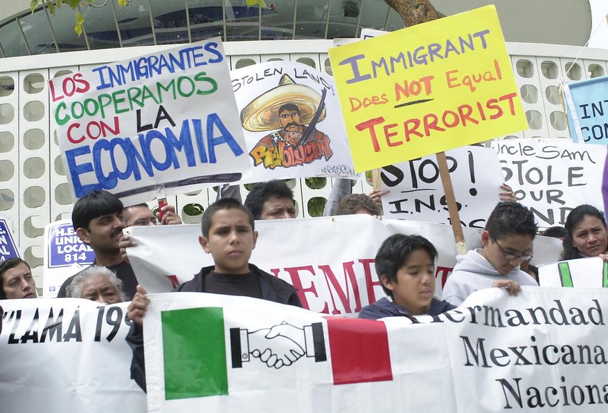 FILE--In this March 28,2002, file photo, protesters gather at Los Angeles International Airport to protest against Immigration and Naturalization Services raids at the facility in Los Angeles.  Throughout U.S. history, critics of federal immigration authorities have sought reforms or abolition in response to new laws and changing federal policies some deemed discriminatory.  (AP Photo/Nick Ut, file)
