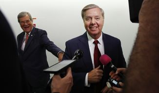 Sen. Lindsey Graham, R-S.C., right, jokes with former Sen. Trent Lott, R-Miss., left, before answering reporters questions about the retirement of Supreme Court Justice Anthony Kennedy Wednesday, June 27, 2018, on Capitol Hill in Washington. (AP Photo/Jacquelyn Martin)