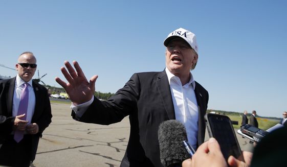 President Donald Trump talks to members of the media before boarding Air Force One at Morristown Municipal Airport, in Morristown, N.J., Sunday, July 8, 2018, en route to Washington from Trump National Golf Club in Bedminster, N.J. (AP Photo/Carolyn Kaster)