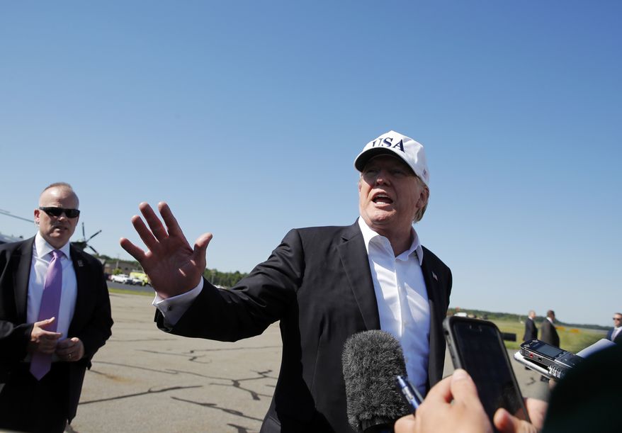 President Donald Trump talks to members of the media before boarding Air Force One at Morristown Municipal Airport, in Morristown, N.J., Sunday, July 8, 2018, en route to Washington from Trump National Golf Club in Bedminster, N.J. (AP Photo/Carolyn Kaster)