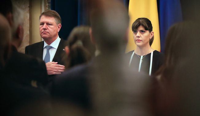 In this Thursday, Feb. 23, 2017 file photo, Romania&#x27;s head of the anti-graft agency (DNA) Laura Codruta Kovesi, right, stands next to Romanian President Klaus Iohhanis, in Bucharest, Romania. President Iohannis fired the beleaguered chief anti-corruption prosecutor Kovesi Monday July 9, 2018, over allegations of  misconduct and incompetence. (AP Photo/Vadim Ghirda, File)