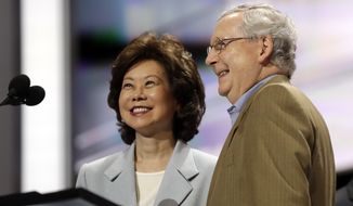 FILE - In this July 17, 2016 file photo, former Labor Secretary Elaine Chao and her husband, Senate Majority Leader Mitch McConnell, R-Ky., check out the stage during preparation for the Republican National Convention inside Quicken Loans Arena in Cleveland. President-elect Donald Trump has picked Elaine Chao to become transportation secretary, according to a Trump source.  (AP Photo/Matt Rourke)