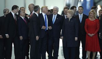 FILE - In this Thursday, May 25, 2017 file photo, Montenegro Prime Minister Dusko Markovic, center right, smiles after appearing to be pushed by U.S. President Donald Trump, center left, during a NATO summit in Brussels. When Donald Trump walks into a NATO summit Wednesday, July 11, 2018,  international politics are bound to become intensely personal _ again. (AP Photo/Matt Dunham, File)