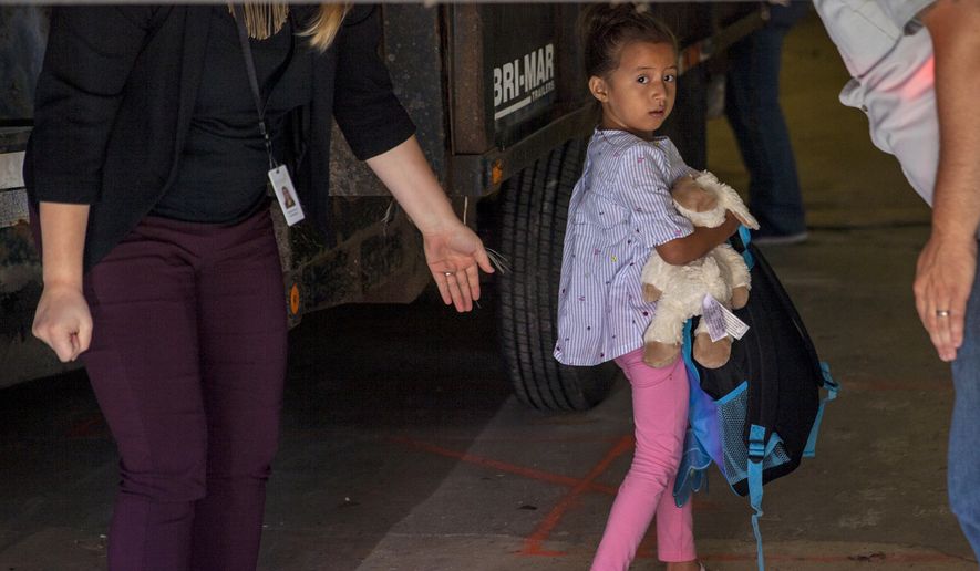 Children taken from their from parents are brought to the U.S. Immigration and Customs Enforcement (ICE) office building in Grand Rapids, Mich., to be reunited with family on Tuesday, July 10, 2018. More than 2,000 children were reportedly separated from their parents after crossing the Southern U.S. border as part of an immigration strategy by the Trump administration.  (Cory Morse/The Grand Rapids Press via AP)