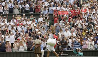 Roger Federer of Switzerland gives a thumbs up after defeating France&#39;s Adrian Mannarino in their men&#39;s singles match, on day seven of the Wimbledon Tennis Championships, in London, Monday July 9, 2018. (AP Photo/Tim Ireland)