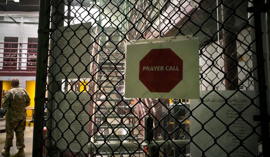 This Wednesday, June 6, 2018, file photo, reviewed by U.S. military officials, shows a placard announcing prayer call at the maximum-security prison at Camp VI, at the Guantanamo Bay U.S. Naval Base, in Guantanamo, Cuba. The detention center opened in January 2002 under President George W. Bush as a makeshift place to hold and interrogate people suspected of involvement with al Qaeda and the Taliban. (AP Photo/Ramon Espinosa) ** FILE **