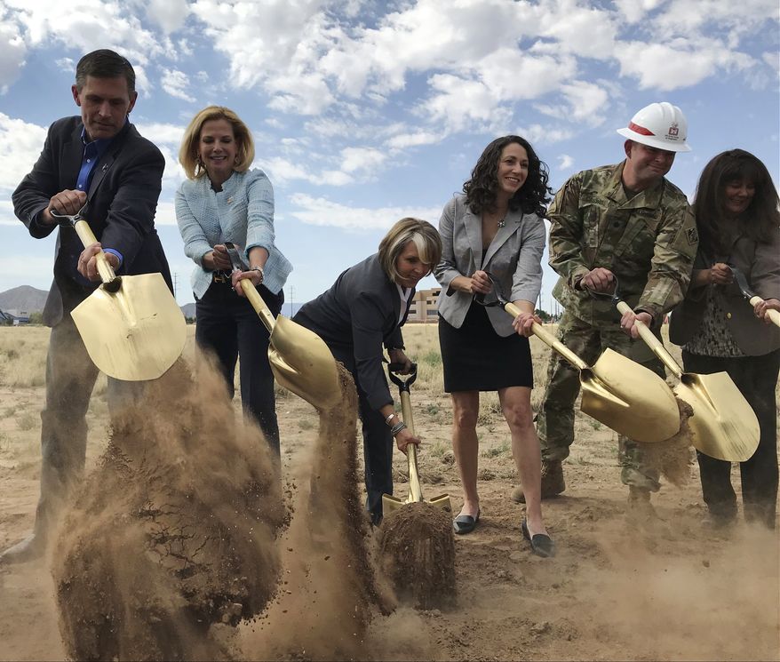 Officials break ground for a new multimillion-dollar new complex that will house employees of the National Nuclear Security Administration in Albuquerque, N.M. Albuquerque with a population of about 600,000, lands thriving tech companies and piles of U.S. military contracts. (AP Photo/Susan Montoya Bryan)
