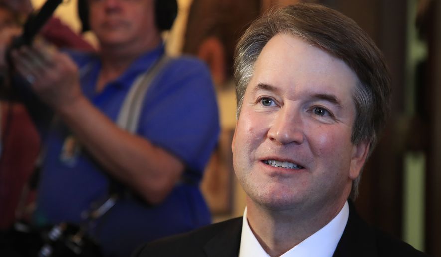 Supreme Court nominee Brett Kavanaugh listens to Sen. Rob Portman, R-Ohio, on Capitol Hill in Washington, during a meeting Wednesday, July 11, 2018. (AP Photo/Manuel Balce Ceneta)