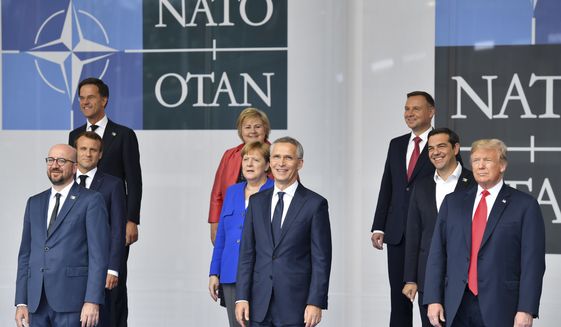 Belgian Prime Minister Charles Michel, French President Emmanuel Macron, Netherland&#39;s Prime Minister Mark Rutte, Norway&#39;s Prime Minister Erna Solberg, German Chancellor Angela Merkel, NATO Secretary-General Jens Stoltenberg, Poland&#39;s President Andrzej Duda, Greek Prime Minister Alexis Tsipras and U.S. President Donald Trump, from left, pose for a photo during a summit of heads of state and government at NATO headquarters in Brussels on Wednesday, July 11, 2018. NATO leaders gather in Brussels for a two-day summit to discuss Russia, Iraq and their mission in Afghanistan. (AP Photo/Geert Vanden Wijngaert)