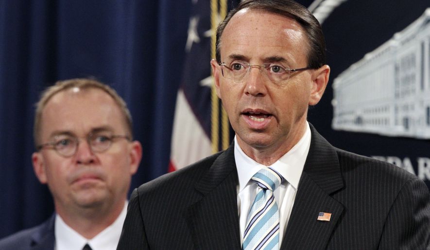Deputy Attorney General Rod Rosenstein, right, with Mick Mulvaney, acting director of the Consumer Financial Protection Bureau, and Director of the Office of Management, speak during a news conference about fraud, Wednesday, July 11, 2018, at the Department of Justice in Washington. (AP Photo/Jacquelyn Martin)