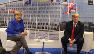 German Chancellor Angela Merkel, left, and U.S. President Donald Trump pose for a photograph prior to a bilateral meeting on the sideline of a summit of heads of state and government at NATO headquarters in Brussels Wednesday, July 11, 2018. NATO leaders gather in Brussels for a two-day summit to discuss Russia, Iraq and their mission in Afghanistan. (AP Photo/Markus Schreiber)