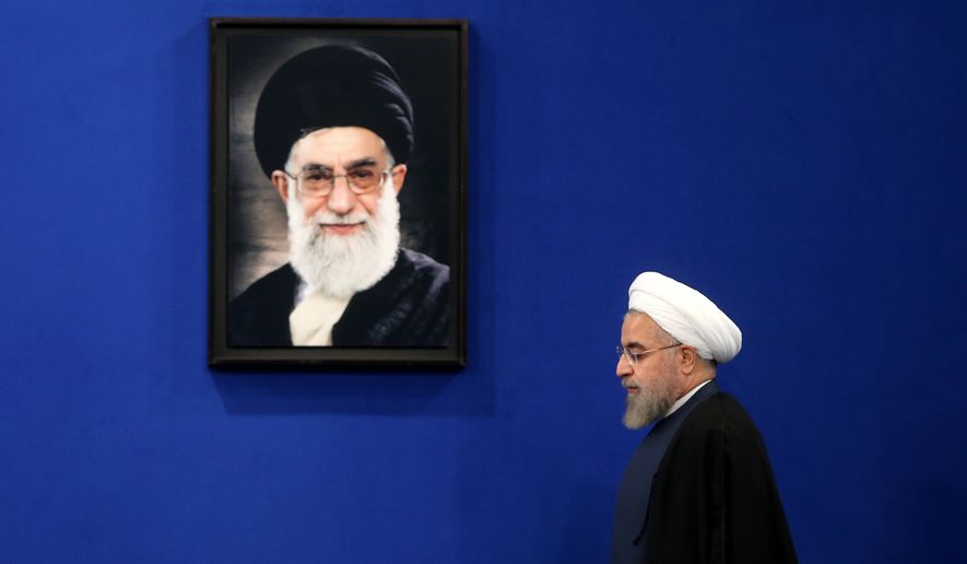 Iran&#39;s President Hassan Rouhani arrives to a press conference in Tehran, Iran, Saturday, Aug. 29, 2015. Rouhani said Saturday he opposed a parliamentary vote on the landmark nuclear deal reached with world powers, saying terms of the agreement will turn into legal obligation if it is passed by the house. Picture of the Supreme Leader Ayatollah Ali Khamenei hangs on the wall. (AP Photo/Ebrahim Noroozi)