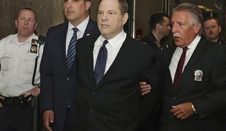 Harvey Weinstein is escorted in handcuffs to a courtroom in New York, Monday, July 9, 2018. Weinstein, who was previously indicted on charges involving two women, was due in court for arraignment on charges alleging he committed a sex crime against a third woman. (AP Photo/Richard Drew)