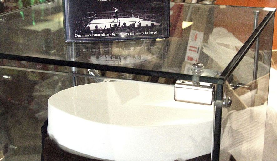 FILE - This May 2, 2018 file photo shows a display case featuring the DVD of the movie "Cinderella Man" and the jockstrap worn by actor Russell Crowe in the movie at a Blockbuster video store in Anchorage, Alaska. Despite the gift of the jockstrap from HBO's John Oliver to bring traffic into the store, Blockbuster Alaska General Manager Kevin Daymude said the last two Blockbuster Video locations in Alaska will rent their last video on Sunday, July 15, 2018, apparently leaving the last Blockbuster Video in Bend, Ore. (AP Photo/Mark Thiessen, File)