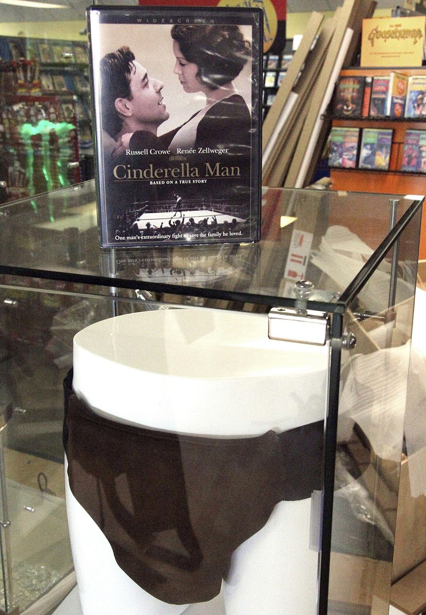 FILE - This May 2, 2018 file photo shows a display case featuring the DVD of the movie "Cinderella Man" and the jockstrap worn by actor Russell Crowe in the movie at a Blockbuster video store in Anchorage, Alaska. Despite the gift of the jockstrap from HBO's John Oliver to bring traffic into the store, Blockbuster Alaska General Manager Kevin Daymude said the last two Blockbuster Video locations in Alaska will rent their last video on Sunday, July 15, 2018, apparently leaving the last Blockbuster Video in Bend, Ore. (AP Photo/Mark Thiessen, File)
