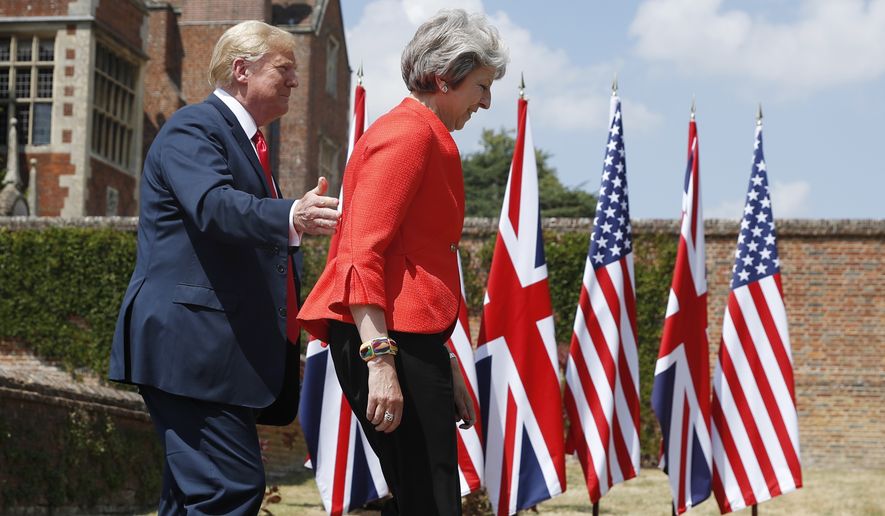 U.S. President Donald Trump with British Prime Minister Theresa May arrive for a joint news conference at Chequers, in Buckinghamshire, England, Friday, July 13, 2018. (AP Photo/Pablo Martinez Monsivais)
