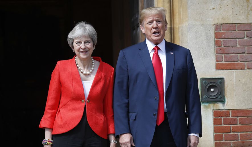 U.S. President Donald Trump, right, stands with British Prime Minister Theresa May, left, at Chequers, in Buckinghamshire, England, Friday, July 13, 2018. (AP Photo/Pablo Martinez Monsivais)