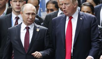 This Saturday, Nov. 11, 2017 file photo, shows U.S. President Donald Trump and Russia&#x27;s President Vladimir Putin talking during the family photo session at the APEC Summit in Danang, Vietnam. When Trump meets Putin on Monday, July 16, 2018, the Syrian conflict will be the most immediately pressing issue on a wide-ranging agenda. (Jorge Silva/Pool Photo via AP, File)