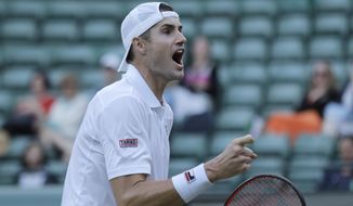 John Isner of the United States celebrates winning his men&#39;s quarterfinals match against Canada&#39;s Milos Raonic, at the Wimbledon Tennis Championships, in London, Wednesday July 11, 2018. (AP Photo/Ben Curtis)