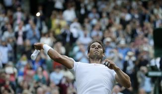 Rafael Nadal of Spain throws his wrist bands into the crowd after defeating Juan Martin Del Potro of Argentina in their men&#39;s quarterfinal match at the Wimbledon Tennis Championships in London, Wednesday July 11, 2018. (AP Photo/Kirsty Wigglesworth)