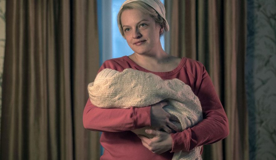 This image released by Hulu shows Elisabeth Moss in a scene from "The Handmaid's Tale." Moss was nominated Thursday for an Emmy for outstanding lead actress in a drama series. The 70th Emmy Awards will be held on Monday, Sept. 17. (George Kraychyk/Hulu via AP)