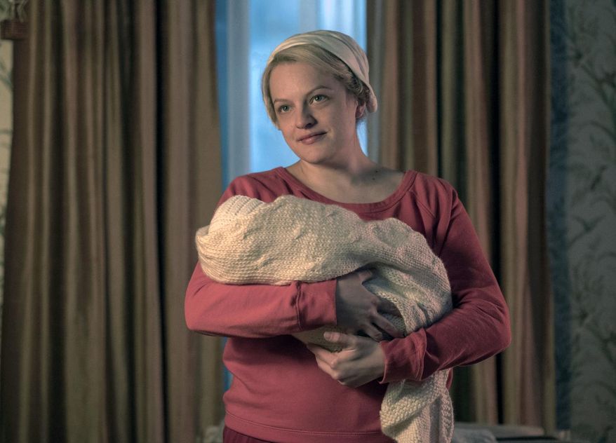 This image released by Hulu shows Elisabeth Moss in a scene from "The Handmaid's Tale." Moss was nominated Thursday for an Emmy for outstanding lead actress in a drama series. The 70th Emmy Awards will be held on Monday, Sept. 17. (George Kraychyk/Hulu via AP)