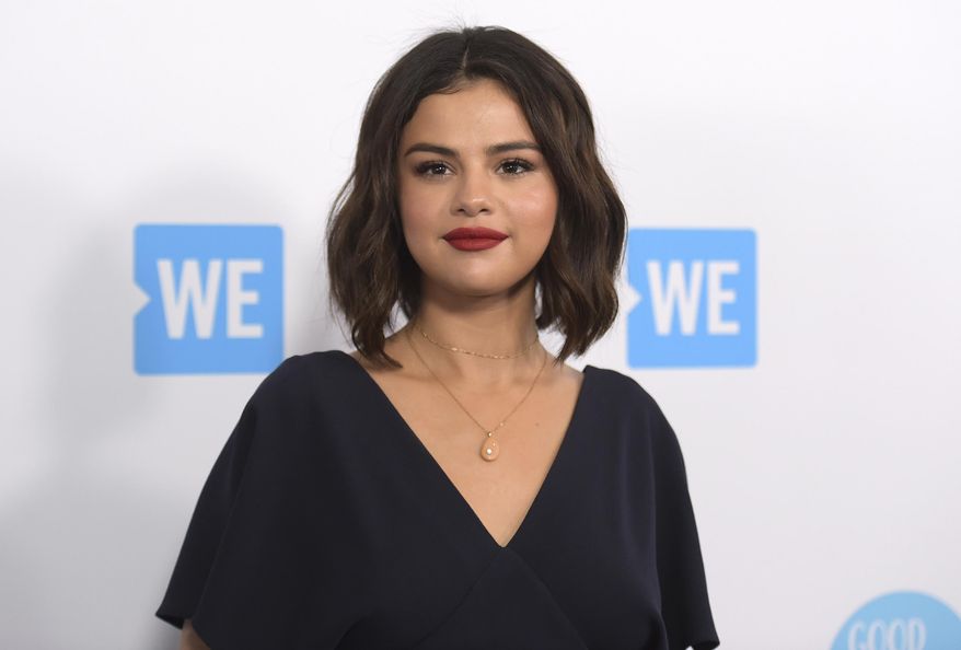 FILE - In this April 19, 2018 file photo, Selena Gomez arrives at WE Day California in Inglewood, Calif. Susan Antrach of Ridgefield Park, New Jersey has been charged with 11 felonies stemming from the hacking of the email of Selena Gomez and one of the actress and singer’s associates. Los Angeles County prosecutors said Friday that Antrach has been charged with five identity-theft counts, five fraud counts and one count of accessing and using data without permission. (Photo by Richard Shotwell/Invision/AP, File)