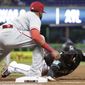 Miami Marlins&#39; Cameron Maybin is picked off at first base as Philadelphia Phillies first baseman Carlos Santana makes the tag during the third inning of a baseball game Friday, July 13, 2018, in Miami. (AP Photo/Lynne Sladky)