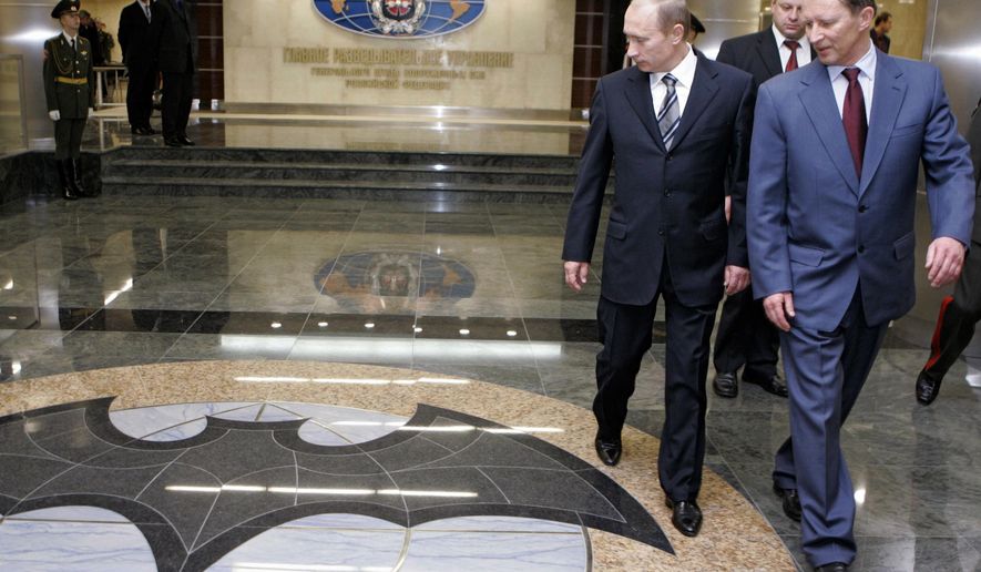 FILE In this file photo taken on Wednesday, Nov. 8, 2006, President Vladimir Putin, second right, and Russian President's special representative on questions of ecology and transport Sergei Ivanov, right, visit the Defense Ministry's Main Intelligence Directorate in Moscow, Russia. The Justice Department has announced charges against 12 Russian intelligence officers for hacking offenses during the 2016 presidential election, it was reported on Friday, July 13, 2018. (Dmitry Astakhov, Sputnik, Kremlin Pool Photo via AP)