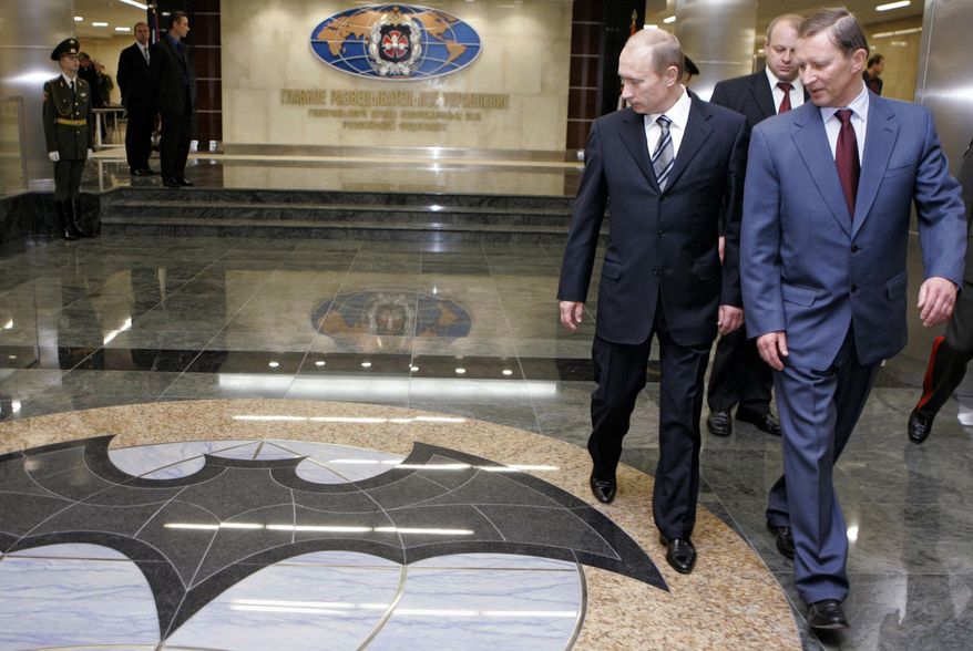 FILE In this file photo taken on Wednesday, Nov. 8, 2006, President Vladimir Putin, second right, and Russian President's special representative on questions of ecology and transport Sergei Ivanov, right, visit the Defense Ministry's Main Intelligence Directorate in Moscow, Russia. The Justice Department has announced charges against 12 Russian intelligence officers for hacking offenses during the 2016 presidential election, it was reported on Friday, July 13, 2018. (Dmitry Astakhov, Sputnik, Kremlin Pool Photo via AP)
