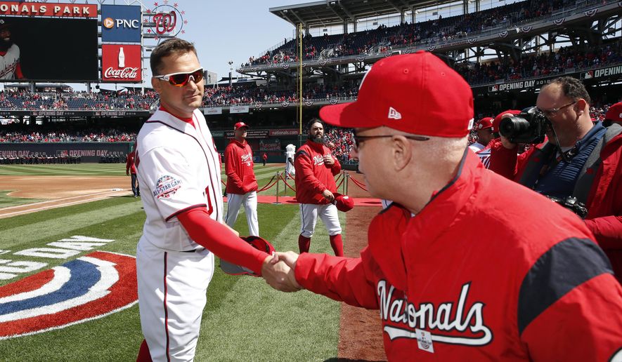 )FILE - In this April 5, 2018, file photo, Washington Nationals first baseman Ryan Zimmerman, left, shakes hands with Washington Nationals owner Mark Lerner before the home opener baseball game against the New York Mets at Nationals Park in Washington. Thirteen years after Major League Baseball returned to Washington and almost that long since Mark and father Ted Lerner were chosen as owners of their new hometown team, they finally get to throw their party. The fourth All-Star Game in the nation’s capital and first since 1969 is a celebration of a new generation of Washingtonians rediscovering the connection to baseball that for so long wasn’t a part of the town’s sporting identity.(AP Photo/Alex Brandon, File)