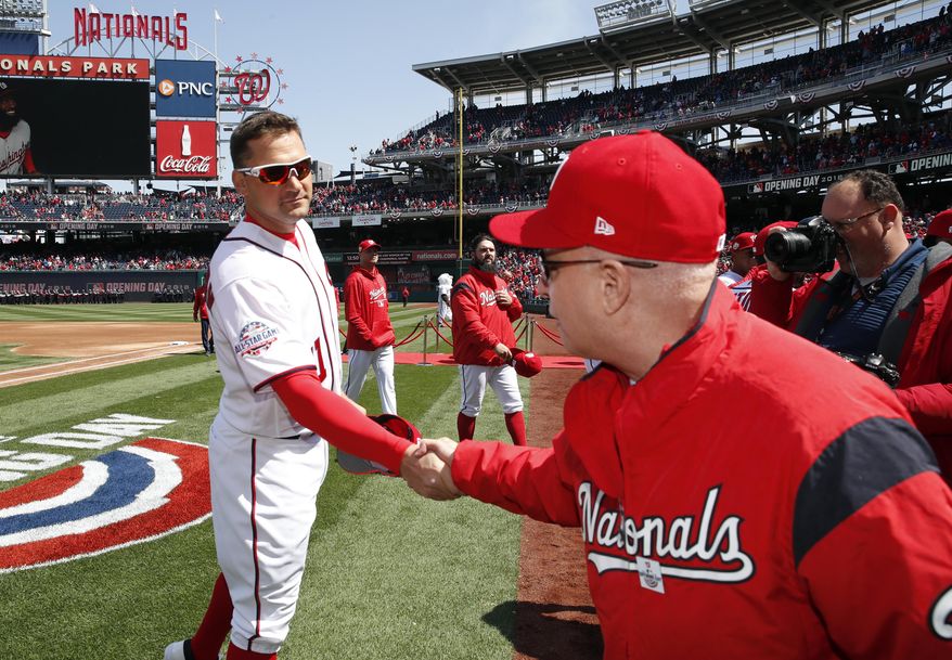)FILE - In this April 5, 2018, file photo, Washington Nationals first baseman Ryan Zimmerman, left, shakes hands with Washington Nationals owner Mark Lerner before the home opener baseball game against the New York Mets at Nationals Park in Washington. Thirteen years after Major League Baseball returned to Washington and almost that long since Mark and father Ted Lerner were chosen as owners of their new hometown team, they finally get to throw their party. The fourth All-Star Game in the nation’s capital and first since 1969 is a celebration of a new generation of Washingtonians rediscovering the connection to baseball that for so long wasn’t a part of the town’s sporting identity.(AP Photo/Alex Brandon, File)